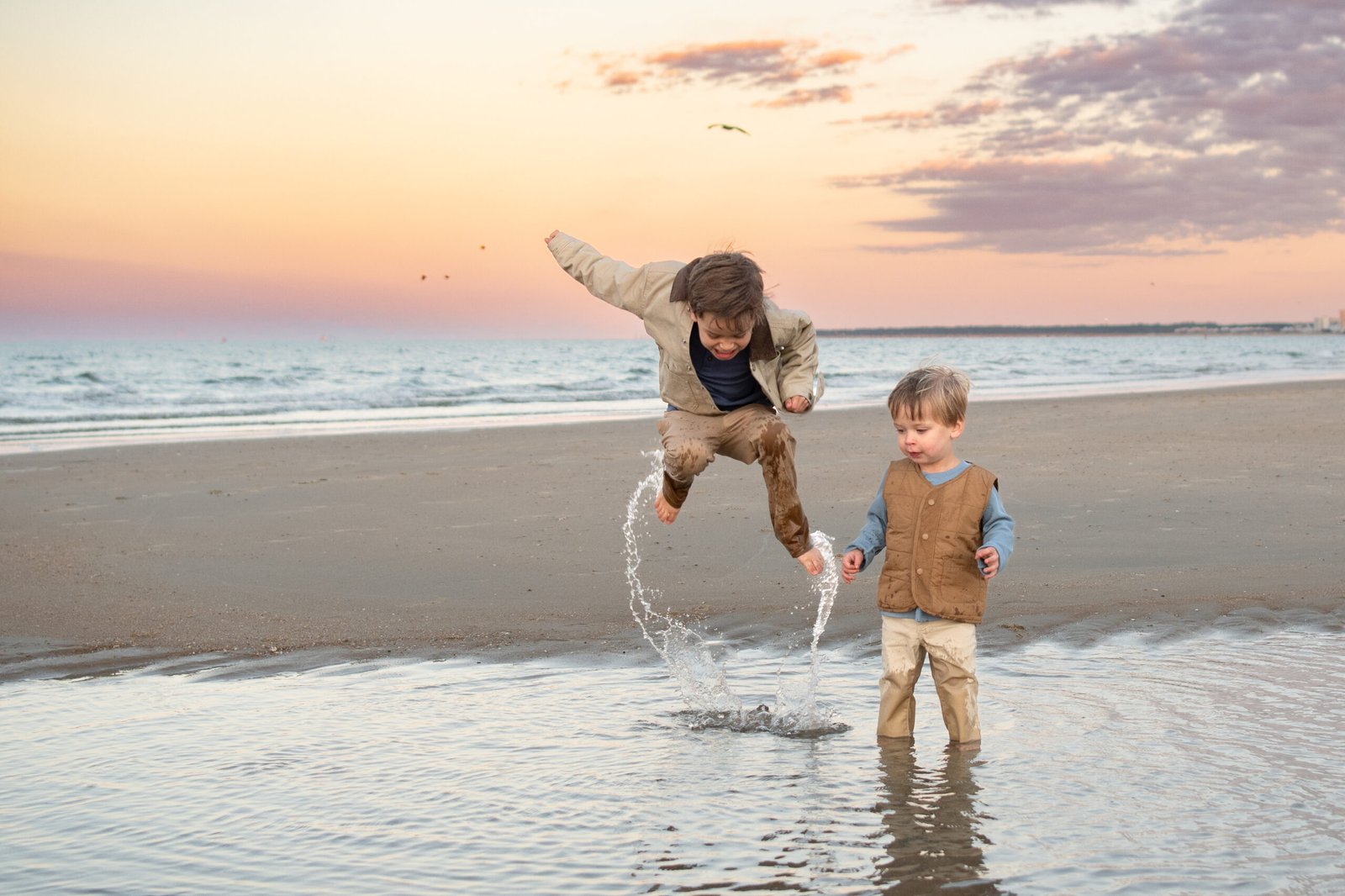 Kids running in the sand at Chic's Beach
