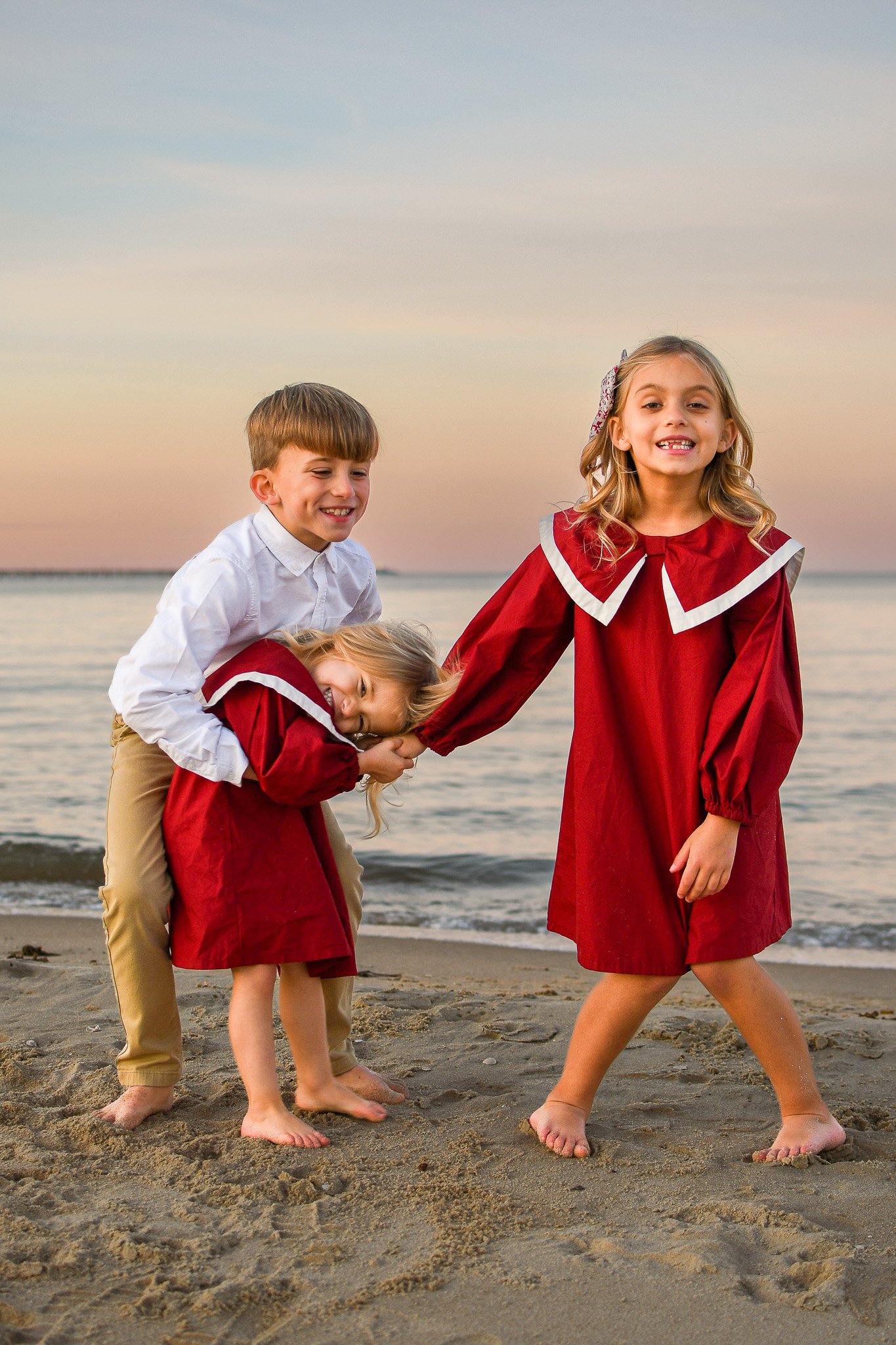 Kids on the beach under a rainbow