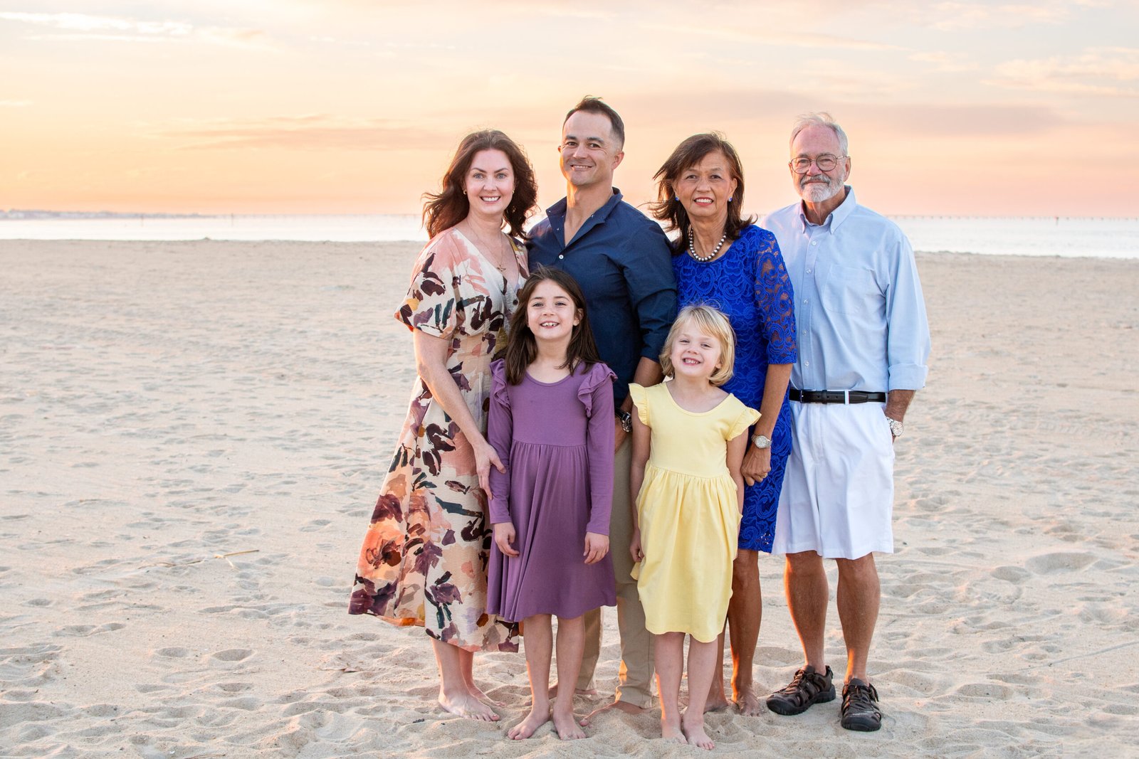 Family in coordinated outfits at the beach in Virginia Beach