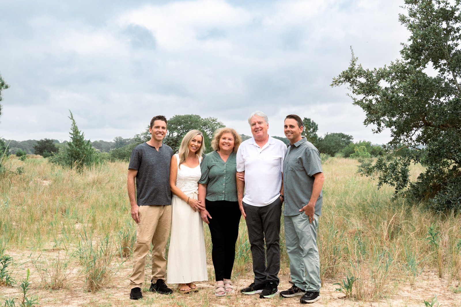 Family in flowy, textured outfits at the beach in Virginia Beach